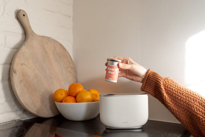 Aera Wellness Sun's Out Capsule in Bright Kitchen with Oranges